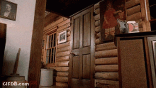 A Wooden Cabin With A Painting On The Wall Above The Door GIF