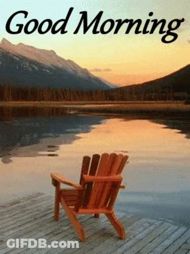 A Wooden Chair Sits On A Dock Near A Lake With Mountains In The Background And The Words Good Morning GIF