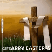A Wooden Cross With A White Ribbon Around It And The Words `` Happy Easter '' Written Below It . GIF
