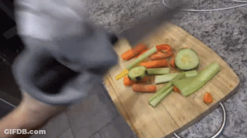 A Wooden Cutting Board With Carrots Celery And Peppers On It GIF