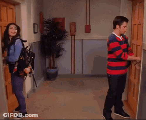 A Wooden Door Is Open To A Room With A Blue Umbrella Hanging On The Wall . GIF