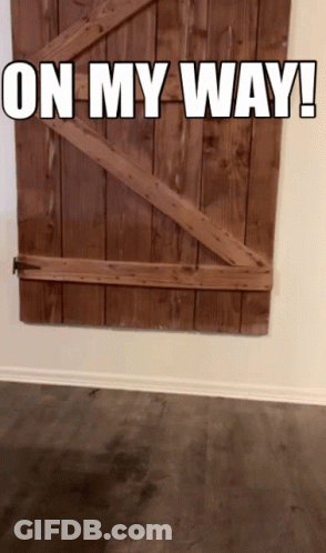 A Wooden Door With The Words " On My Way " Written On It GIF