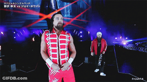 A Wrestler In A Red And White Outfit Is Walking Down A Ramp GIF