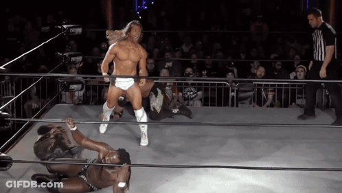 A Wrestler In A Ring With A Referee In The Background GIF