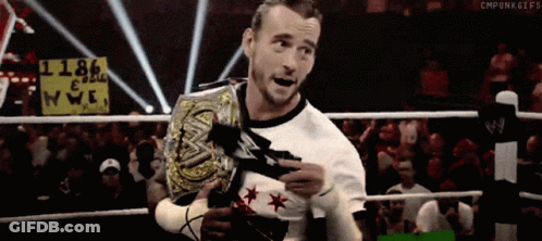 A Wrestler In A Ring With A Sign That Says 1186 On It GIF