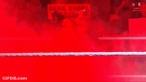 A Wrestler In A Ring With A Sign That Says Dark Angel On It GIF