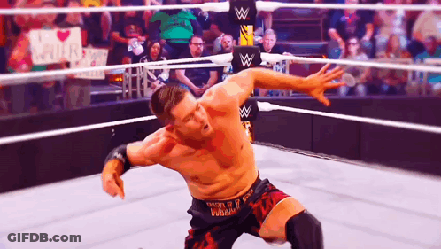 A Wrestler In A Ring With A Sign That Says I Love You GIF