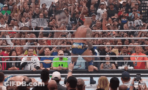 A Wrestler In A Ring With A Sign That Says Shine GIF