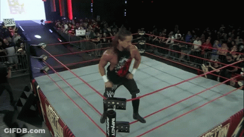 A Wrestler In A Ring With A Sign That Says Too Sweet On It GIF