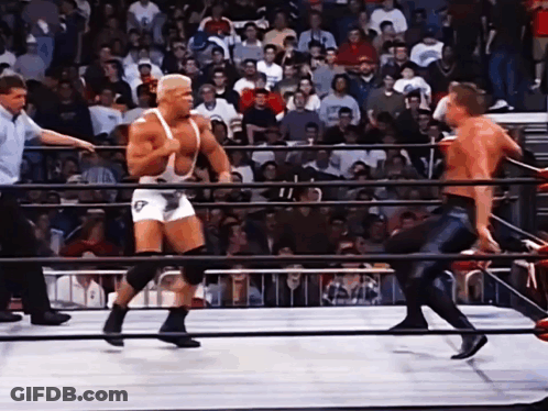 A Wrestler In A White Singlet With The Letter T On It GIF