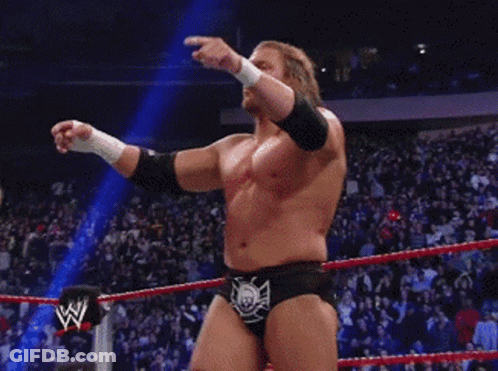 A Wrestler In A Wrestling Ring With The Letter W On The Side Of His Belt GIF