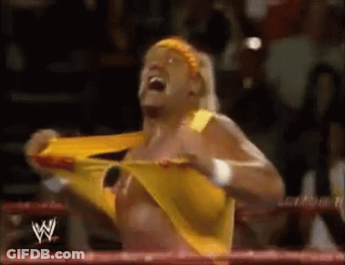 A Wrestler In A Yellow Shirt Is Screaming In A Ring . GIF