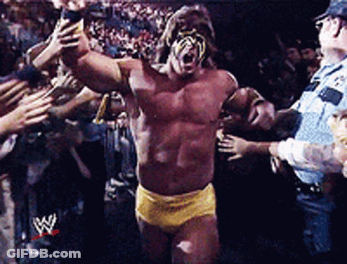 A Wrestler In A Yellow Shorts Is Surrounded By Fans GIF