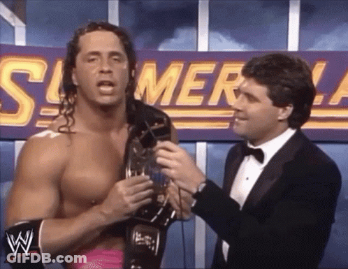 A Wrestler Is Being Interviewed By A Man In A Tuxedo In Front Of A Sign That Says Summerslam . GIF