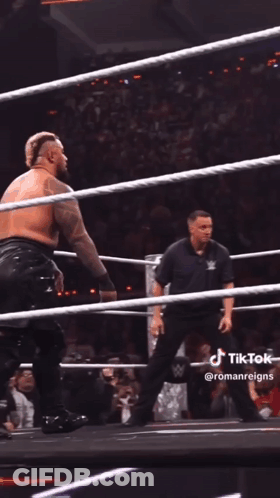 A Wrestler Is Being Lifted In The Air By Another Wrestler During A Match GIF