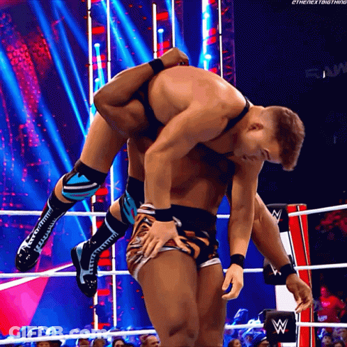 A Wrestler Is Carrying Another Wrestler On His Back GIF