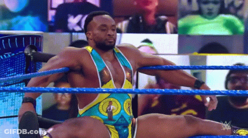 A Wrestler Is Doing A Split In The Ring During A Wrestling Match . GIF