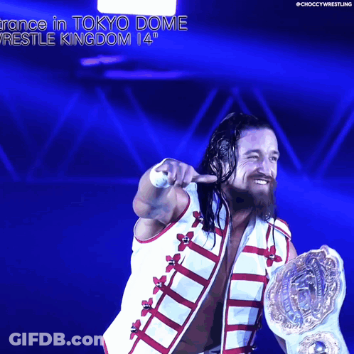 A Wrestler Is Holding A World Heavyweight Championship While Pointing At The Camera GIF