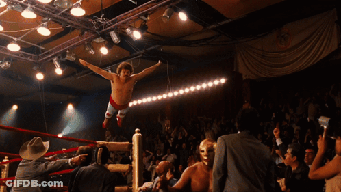 A Wrestler Is Jumping In The Air In A Ring GIF
