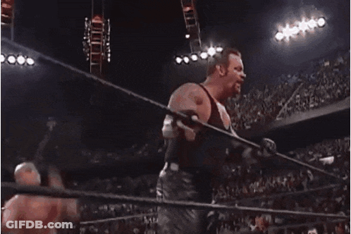 A Wrestler Is Jumping Over A Rope In A Ring GIF