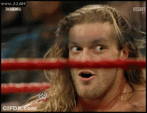 A Wrestler Is Looking Through A Red Ring And The Website Www.jj.am Is Displayed GIF