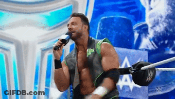 A Wrestler Is Singing Into A Microphone While Standing In A Ring GIF