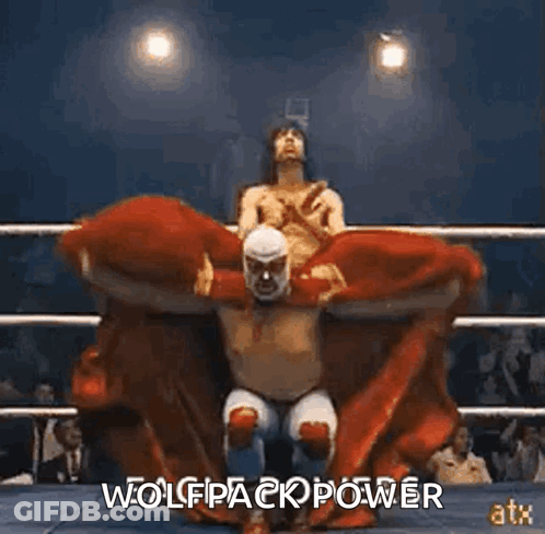 A Wrestler Is Sitting On Another Wrestler 'S Shoulders In A Ring . GIF