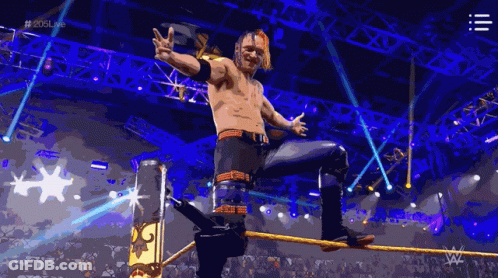 A Wrestler Is Standing On A Rope In A Wrestling Ring With The Hashtag # 2015Live GIF