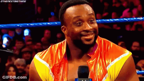 A Wrestler Is Talking Into A Microphone In A Wrestling Ring . GIF