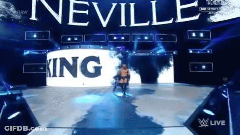 A Wrestler Is Walking Down A Stage With The Word Neville In The Background GIF