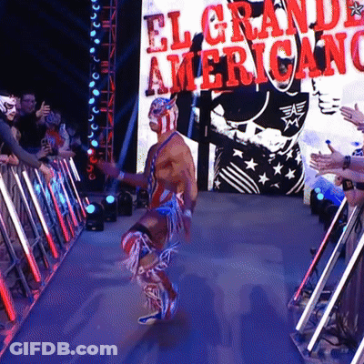 A Wrestler Is Walking Through A Tunnel With A Sign That Says El Grande Americano GIF