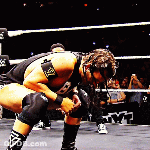 Wrestler Kneeling In Ring With Crowd GIF