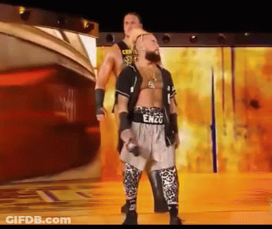 A Wrestler Named Enzo Is Standing Next To Another Wrestler On A Stage GIF