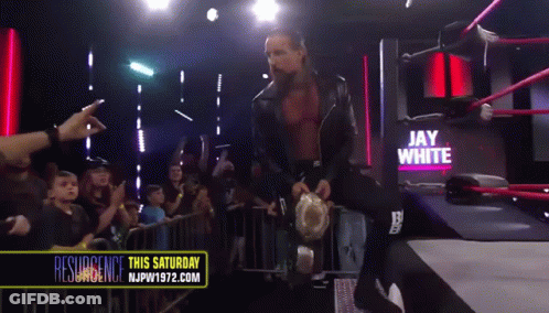 A Wrestler Named Jay White Is Walking Out Of A Ring GIF