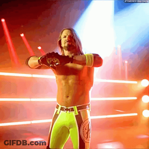 A Wrestler Stands In A Ring With His Arms Outstretched In Front Of A Screen That Says Thenextbig Thing GIF