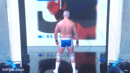 A Wrestler Stands In Front Of A Screen That Says I Be On It GIF