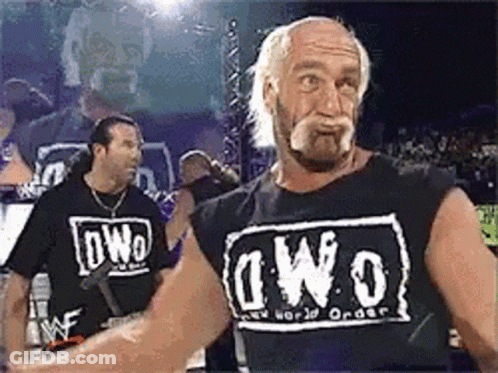 A Wrestler Wearing A Black Shirt That Says Nwo On It GIF