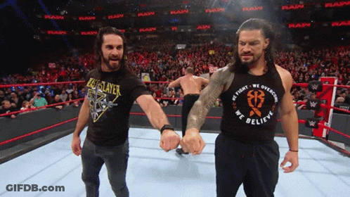 A Wrestler Wearing A Black Shirt That Says We Fight We Overcome We Believe GIF