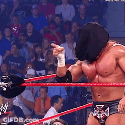 A Wrestler Wearing A Mask And A Belt That Says The Next Thing On It GIF
