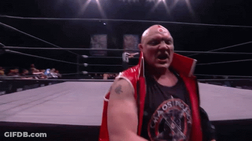 A Wrestler Wearing A Red Vest And A Black Shirt That Says Osprey GIF