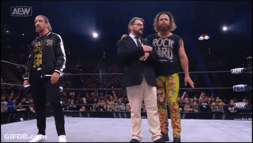 A Wrestler Wearing A Shirt That Says Rock N ' Roll GIF