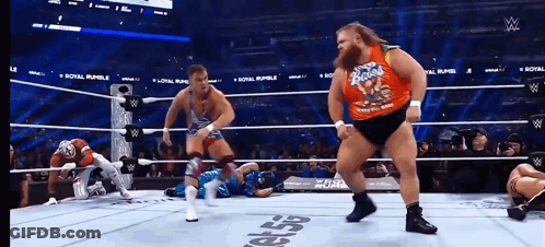 A Wrestler Wearing A Shirt That Says ' Rocky Road ' On It GIF