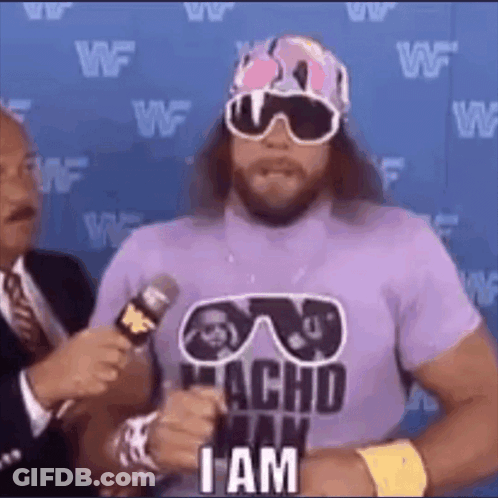 A Wrestler Wearing Sunglasses And A Purple Shirt Is Talking Into A Microphone And Saying `` I Am '' . GIF