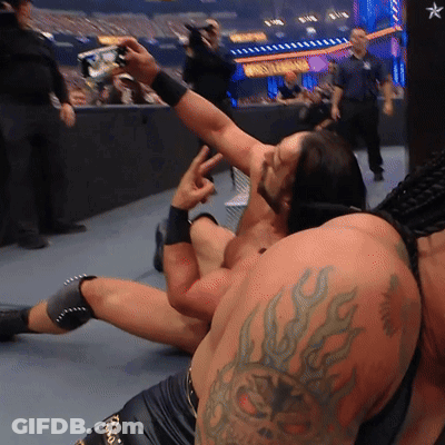 A Wrestler With A Tattoo On His Arm Takes A Picture GIF