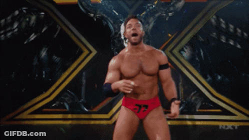 A Wrestler With The Number 37 On His Shorts Stands On A Stage GIF