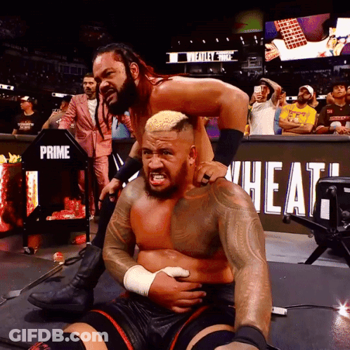 A Wrestling Match Is Being Held In Front Of A Sign That Says Prime Wheat GIF