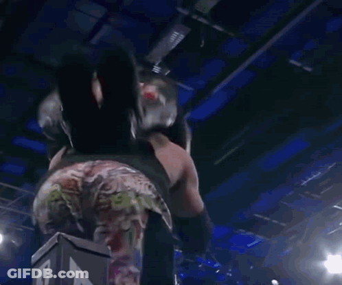 A Wrestling Match Is Going On In Front Of A Crowd With A Sign That Says " I Love You " On It GIF