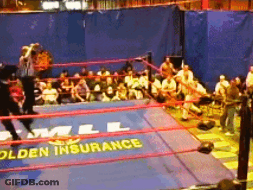 A Wrestling Ring With A Sign That Says " Golden Insurance " GIF