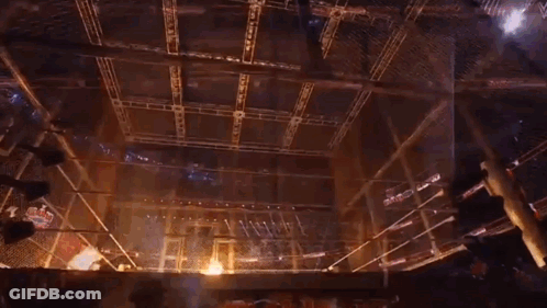 A Wrestling Ring With Flames Coming Out Of The Ropes . GIF