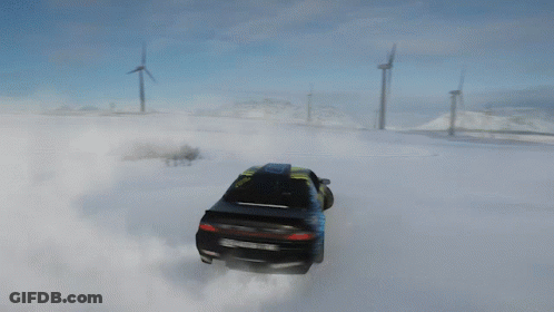 A Yellow And Black Car Is Drifting In The Snow With A Wind Turbine In The Background GIF